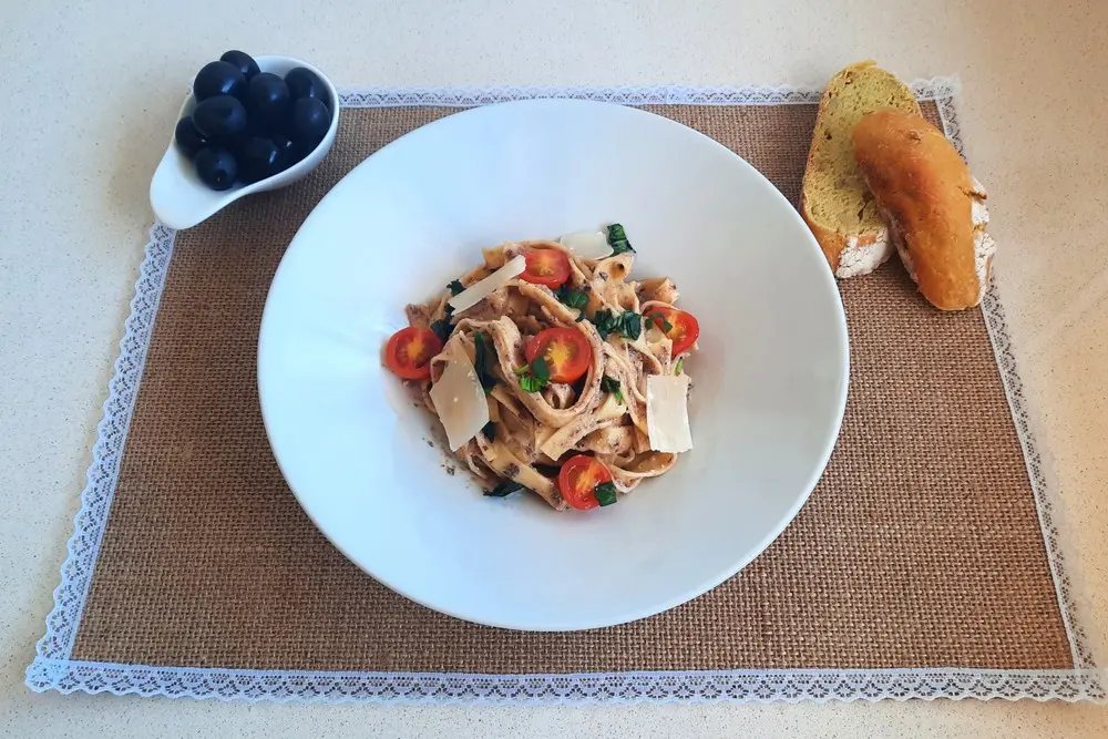 Pasta con pesto de aceitunas negras y tomates cherry